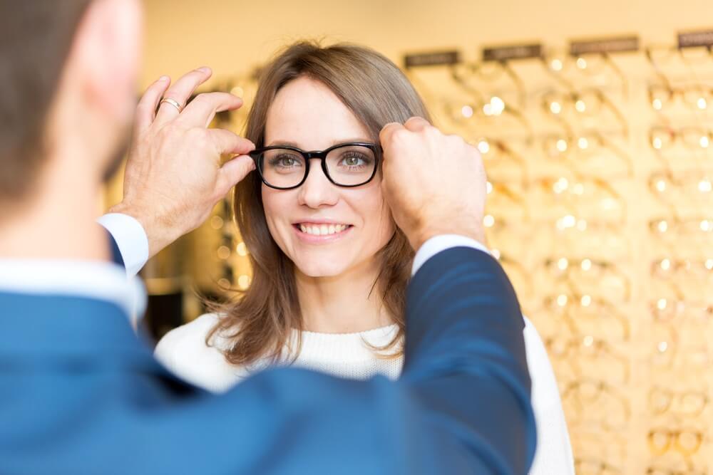 Woman trying on eye glasses