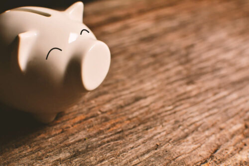 Pink piggy bank on wood table