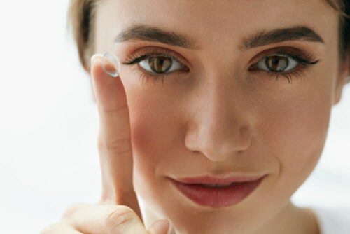 Beautiful woman with contact on finger