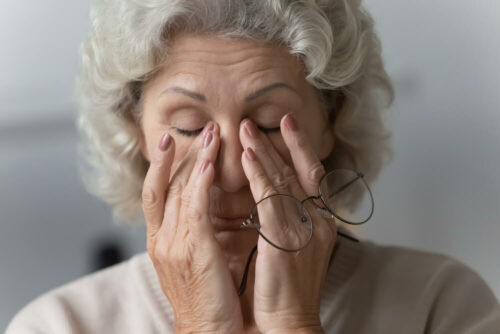 Older woman rubbing her eyes