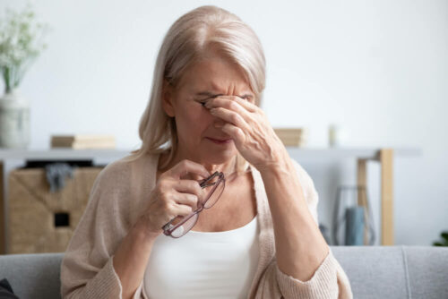 Older woman rubbing eyes