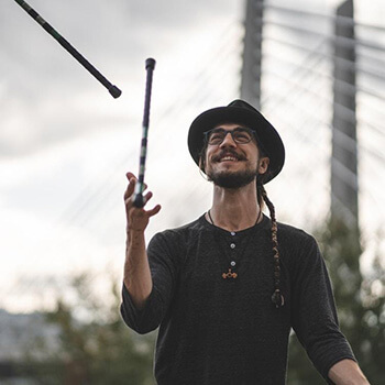 Man juggling sticks