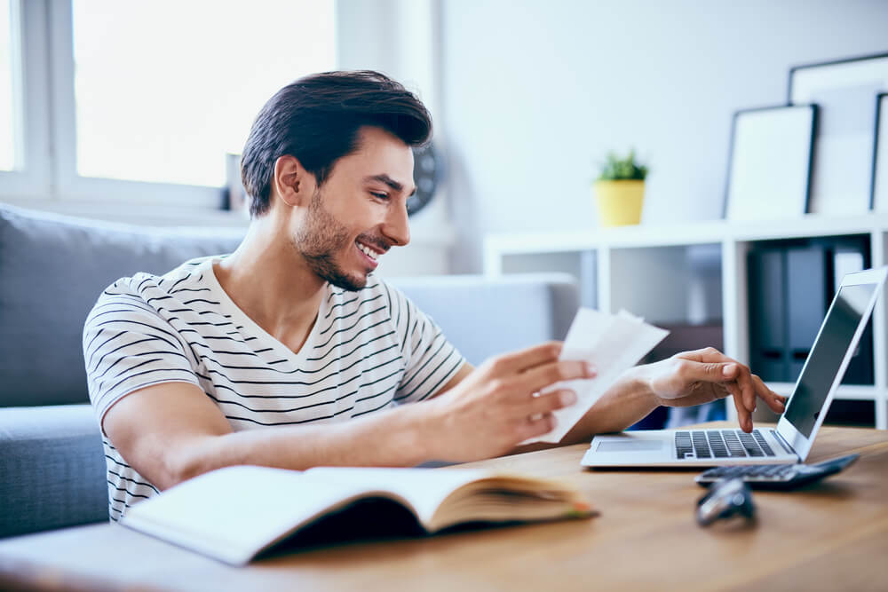 Man paying a bill online with laptop