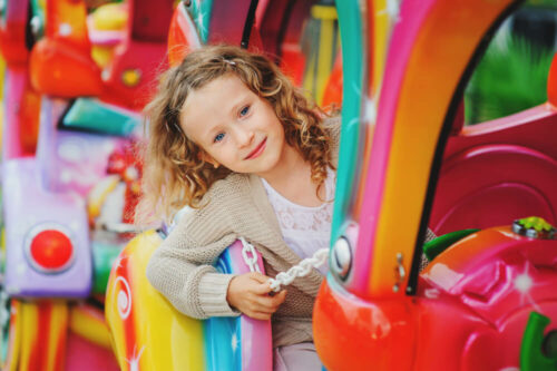 child on colorful ride
