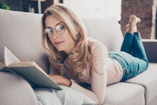 Lady reading book with glasses on