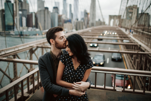 couple standing on bridge