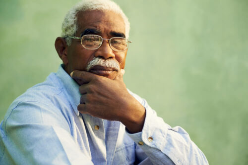 Older man with hand on chin