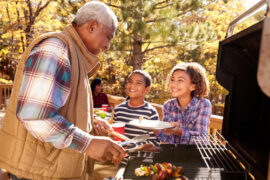 Man Grilling with Family