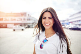 Girl with brunette hair smiling at camera