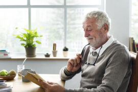 Older man reading about cataracts