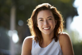 Lady in white shirt looking into camera.