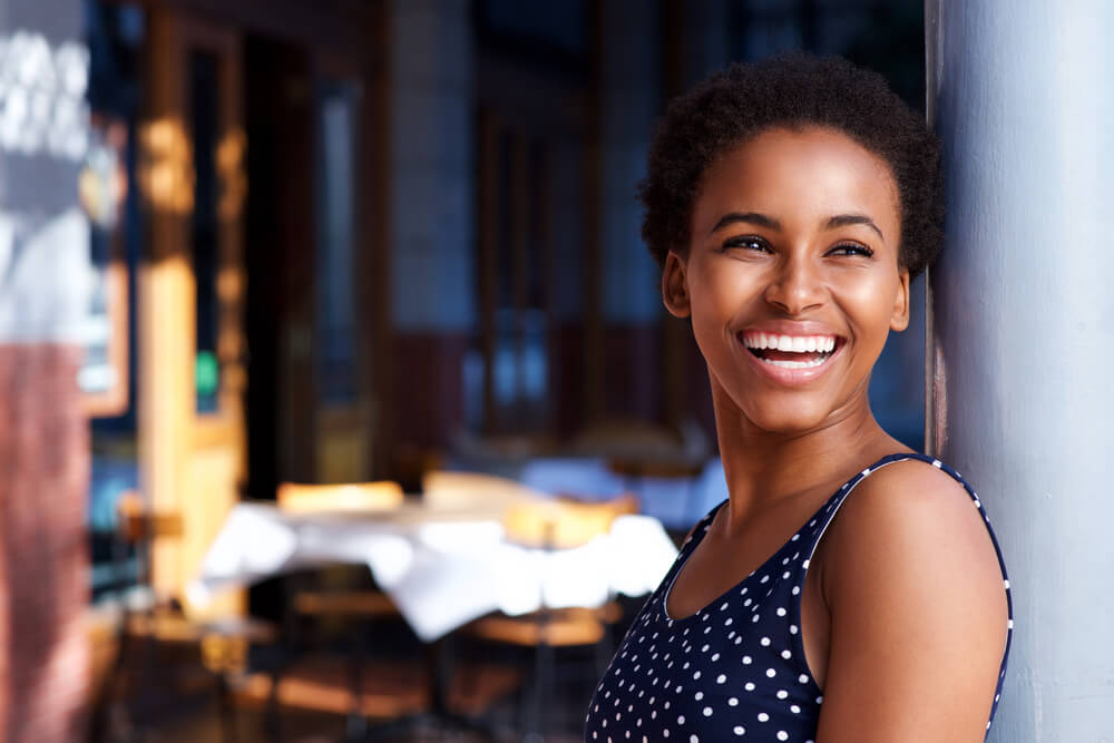 Woman outside of a restaurant smiling
